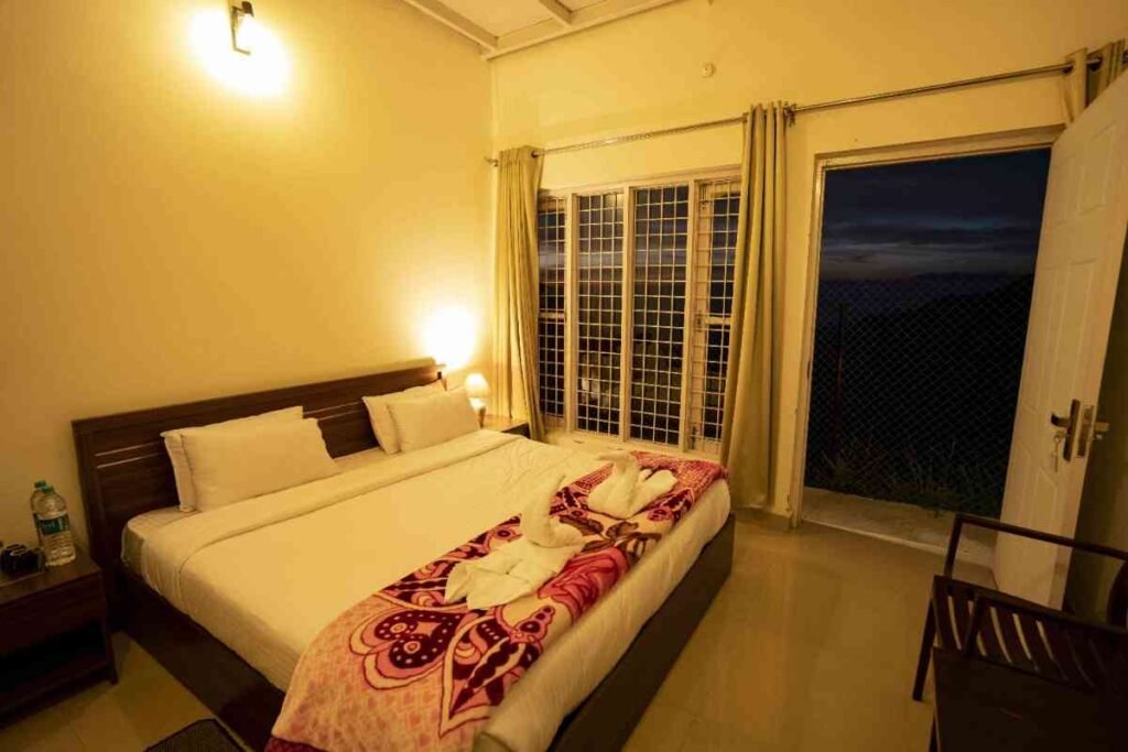 Cozy bedroom in r-2.jpg with bed, swan towels, and open door